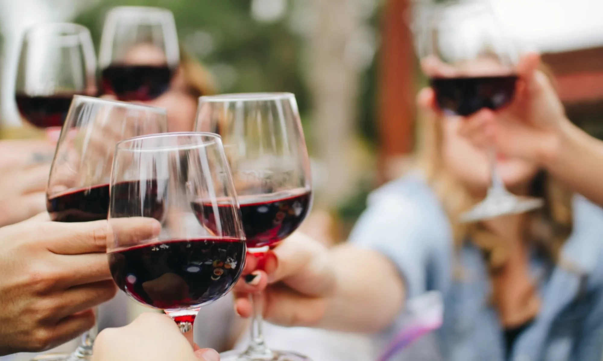 people drinking red wine, symbolic of an advent wine calendar