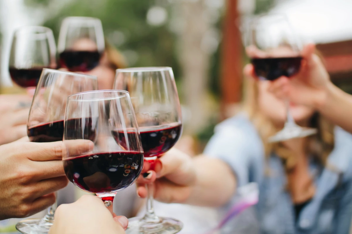 people drinking red wine, symbolic of an advent wine calendar